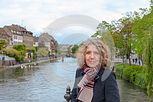 Attractive middle-aged woman posing on a bridge