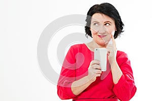 Attractive middle-aged woman relaxing reading her text messages on her mobile phone with a quiet smile copy space