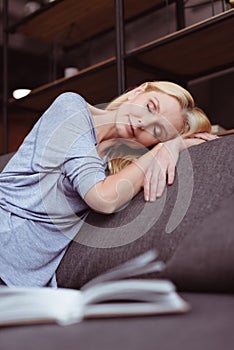 attractive middle aged woman sleeping on sofa