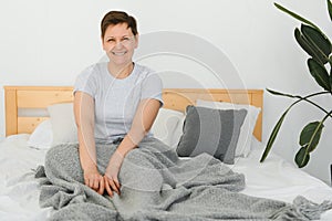 Attractive Middle Aged Woman Waking Up In Bed.