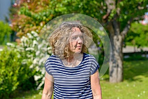 Attractive middle-aged woman walking in a garden