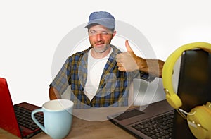 Attractive millennial business man working with laptop computer as internet blogger and technology geek in online successful job a