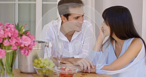 Attractive mixed couple having wine together