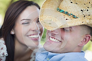 Attractive Mixed Race Couple with Cowboy Hat Flirting