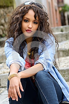 Attractive mixed woman in urban background wearing