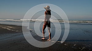 Attractive model walking by the seashore