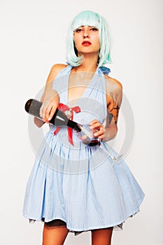 Attractive model woman pouring wine in a glass