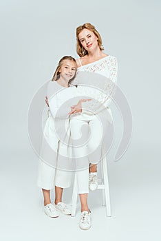 attractive mother sitting on stool and