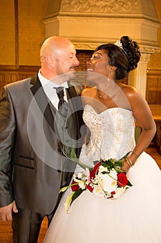 Attractive multi racial couple african bride and american caucasian groom during wedding celebration