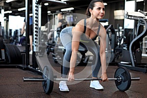 Attractive muscular fit woman exercising building muscles