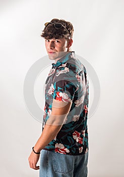 Attractive, muscular young man smiling, wearing open hawaian style shirt