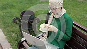 Attractive muslim business woman eating healthy salad while having break during work.