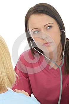 Attractive Natural Young Professional Female Doctor Listening Carefully With A Stethoscope