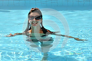 Attractive nice girl in bikini in a pool