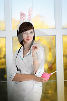 attractive nurse in a dressing gown with ears of rabbit