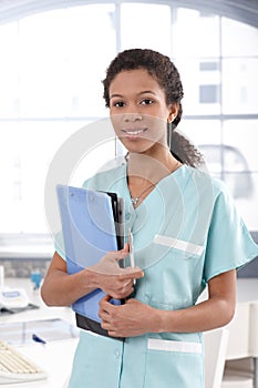 Attractive nurse holding case sheets