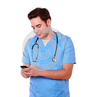 Attractive nurse man texting on cellphone