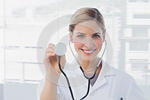 Attractive nurse showing her stethoscope