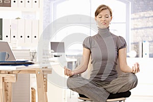 Attractive office worker practicing yoga