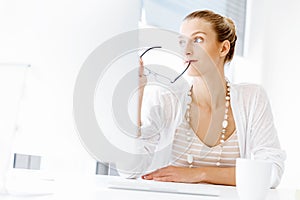 Attractive office worker sitting at desk