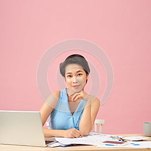 Attractive office worker sitting at desk