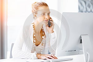 Attractive office worker sitting at desk