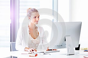 Attractive office worker sitting at desk