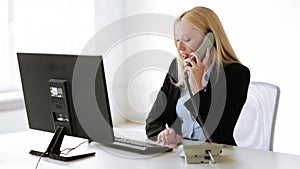 Attractive office worker taking phone call