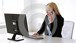 Attractive office worker taking phone call