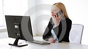 Attractive office worker taking phone call