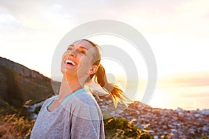 Attractive older woman laughing outdoors during sunset photo