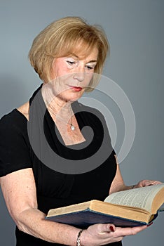 Attractive older woman reading book