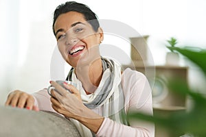 attractive older woman sat on sofa