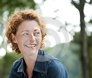 Attractive older woman smiling and looking away