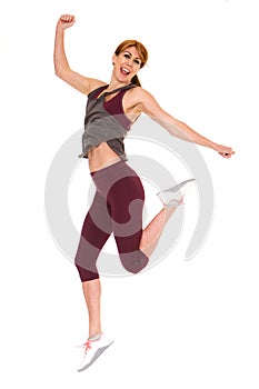 Attractive older woman in sportswear jumping