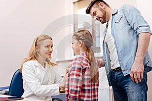 Attractive pediatrician wearing stethoscope on ears