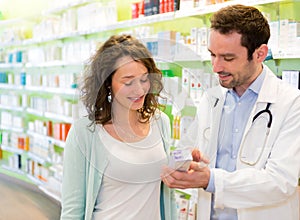 Attractive pharmacist advising a patient