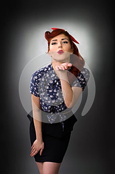 Attractive pin up girl blowing a kiss