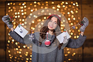 Attractive positive young woman holding handmade christmas decoration