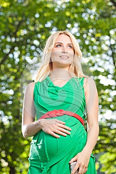 Attractive Pregnant Woman In Green Dress