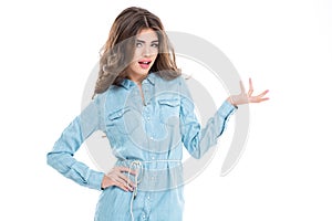 Attractive pretty woman in casual dress holding copyspace on palm