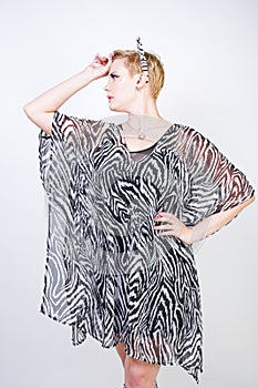 Attractive pretty woman wearing zebra dress in studio