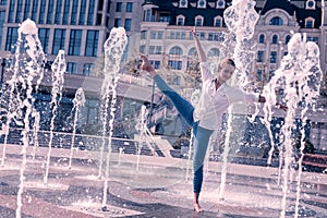 Attractive professional dancer dancing in the city
