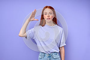 attractive readhead woman with raised palm demonstrating no gest