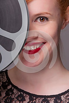 Attractive redhead with film reel