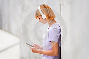 Attractive redhead woman listening to music