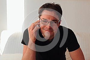 Attractive and relaxed man smiling while telephone call