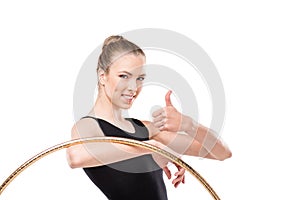 Attractive rhythmic gymnast in bodysuit with hoop showing thumb up