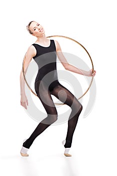 Attractive rhythmic gymnast in bodysuit posing with hoop