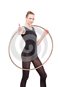 Attractive rhythmic gymnast in leotard with hoop showing thumb up